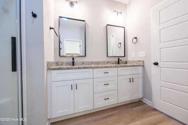 6001 Farmwood Loop, Wilson, NC 27896 - full bathroom featuring double vanity and wood finished floors