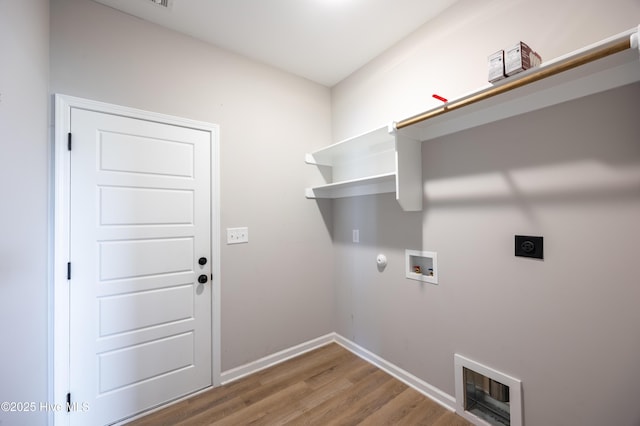 6001 Farmwood Loop, Wilson, NC 27896 - laundry area with hookup for an electric dryer, washer hookup, wood finished floors, heating unit, and gas dryer hookup