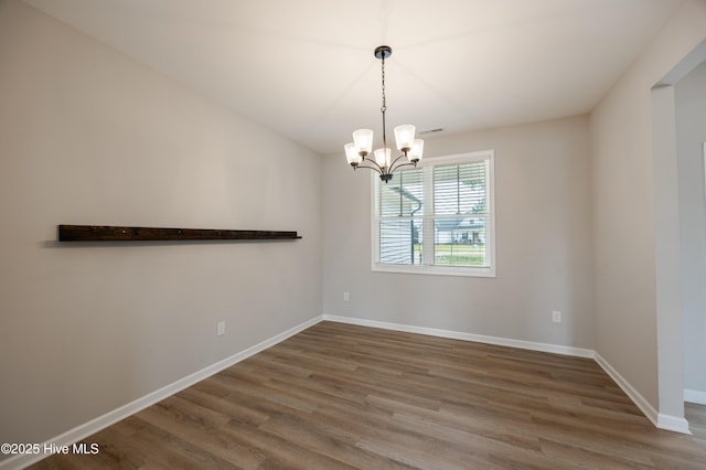 6001 Farmwood Loop, Wilson, NC 27896 - unfurnished room with wood finished floors and a chandelier