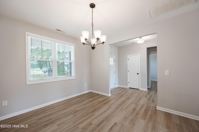 6001 Farmwood Loop, Wilson, NC 27896 - empty room featuring a chandelier and light wood-style flooring