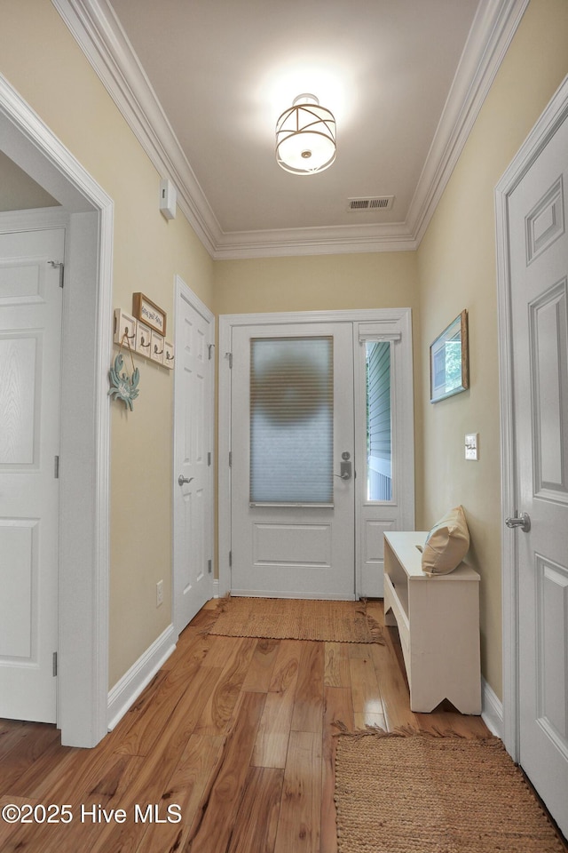 215 NE 54th St, Oak Island, NC 28465 - entryway featuring light wood-style flooring and crown molding