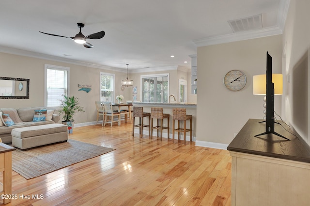 215 NE 54th St, Oak Island, NC 28465 - living area with crown molding, light wood-type flooring, ceiling fan, and recessed lighting