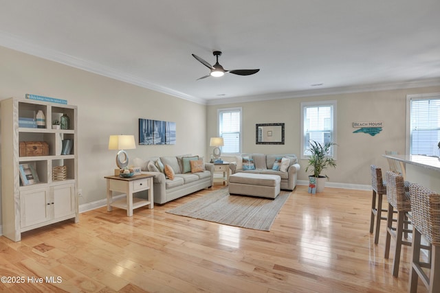 215 NE 54th St, Oak Island, NC 28465 - living area featuring ceiling fan, light wood-type flooring, and ornamental molding