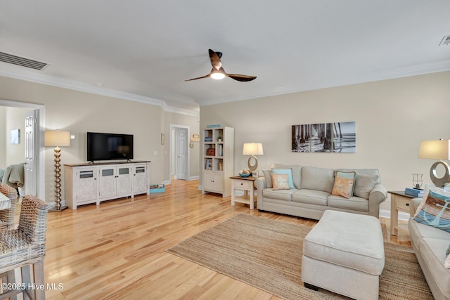 215 NE 54th St, Oak Island, NC 28465 - living room featuring ceiling fan, crown molding, and wood finished floors