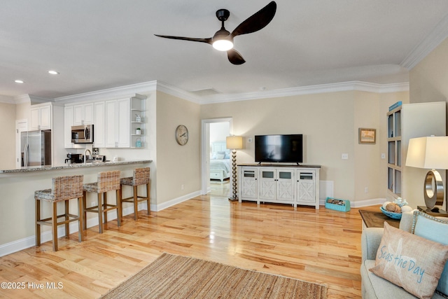 215 NE 54th St, Oak Island, NC 28465 - living area featuring crown molding, light wood-type flooring, a ceiling fan, and recessed lighting