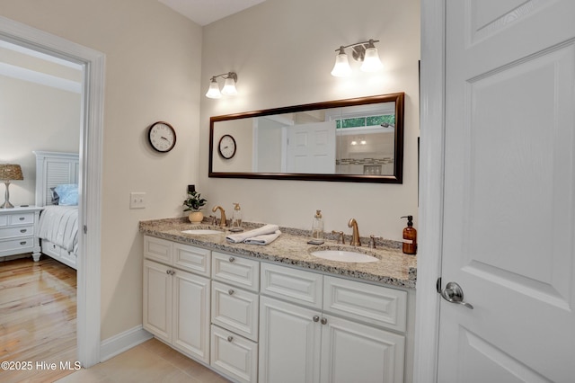 215 NE 54th St, Oak Island, NC 28465 - ensuite bathroom featuring double vanity and baseboards