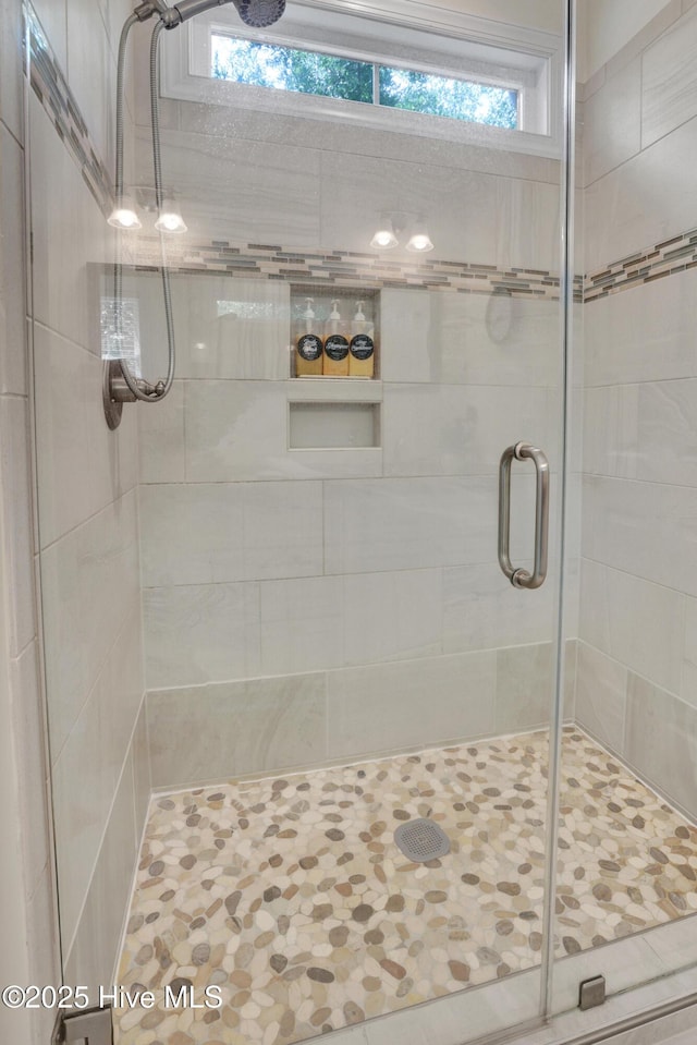215 NE 54th St, Oak Island, NC 28465 - bathroom featuring a shower stall and plenty of natural light