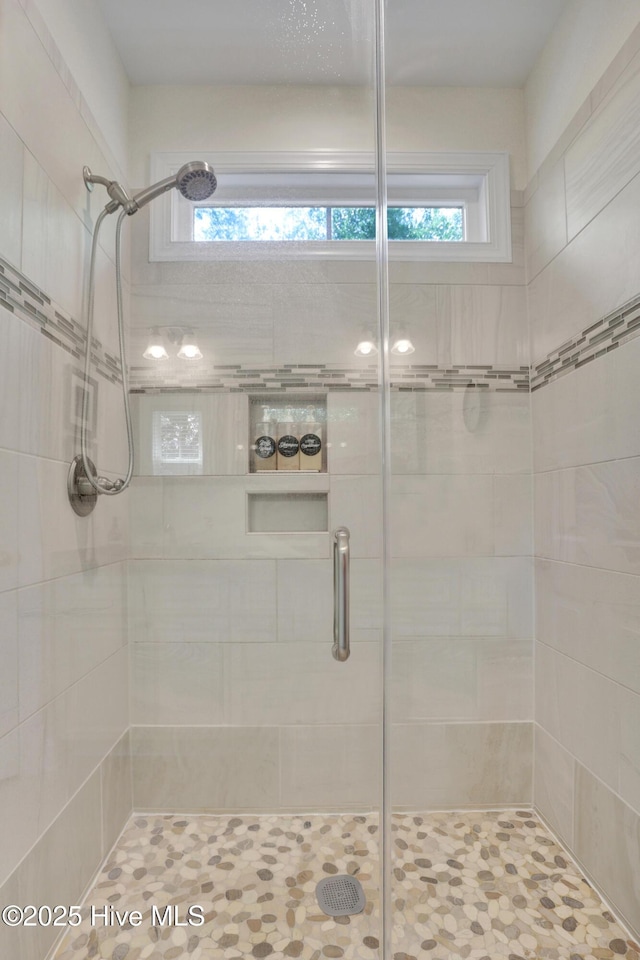 215 NE 54th St, Oak Island, NC 28465 - full bath featuring a stall shower and healthy amount of natural light
