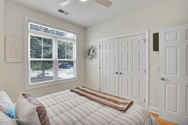 215 NE 54th St, Oak Island, NC 28465 - bedroom with a closet, light wood finished floors, and a ceiling fan