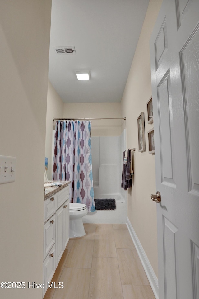 215 NE 54th St, Oak Island, NC 28465 - full bathroom featuring vanity, shower / tub combo with curtain, and tile patterned floors
