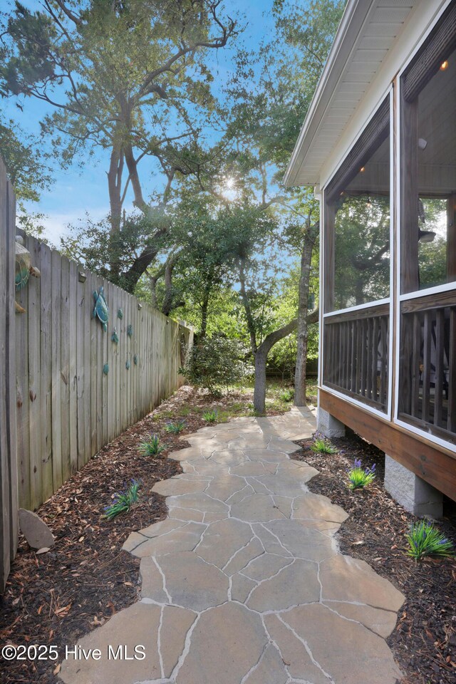 215 NE 54th St, Oak Island, NC 28465 - view of patio featuring a sunroom
