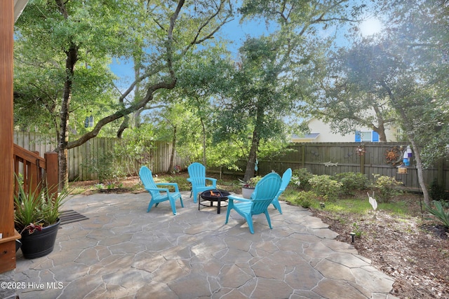 215 NE 54th St, Oak Island, NC 28465 - fenced backyard with a fire pit and a patio