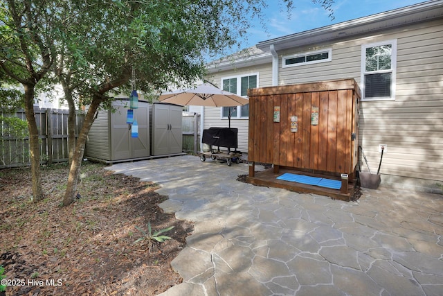 215 NE 54th St, Oak Island, NC 28465 - view of patio with a storage unit