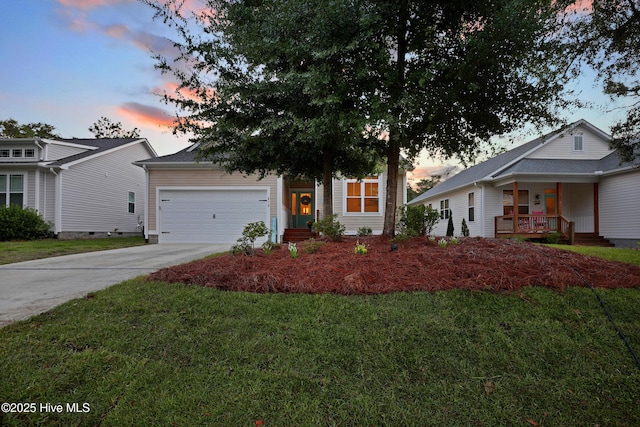 215 NE 54th St, Oak Island, NC 28465 - view of front of home featuring driveway, a garage, a front lawn, and covered porch
