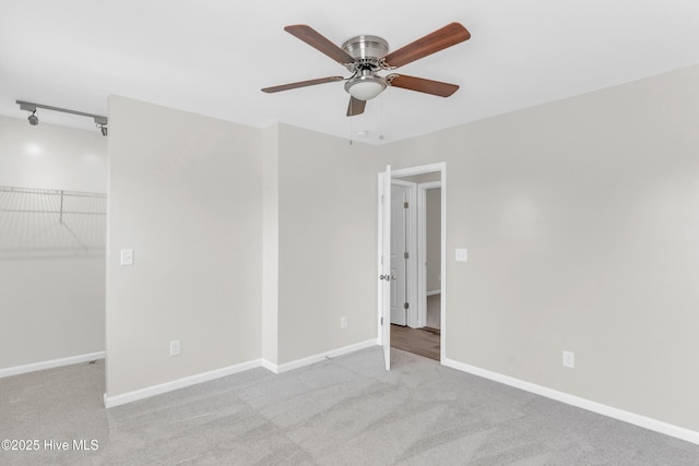 1004 S 8th St, Wilmington, NC 28401 - unfurnished bedroom with light carpet, a spacious closet, ceiling fan, and a closet