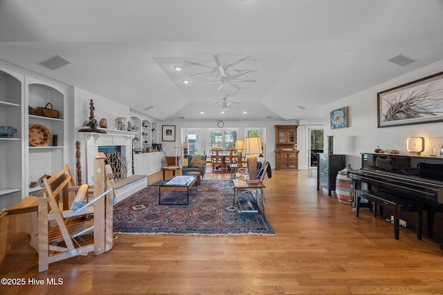 110 Mariners Ct, New Bern, NC 28562 - living area with ceiling fan, a fireplace with raised hearth, lofted ceiling, light wood-style floors, and recessed lighting