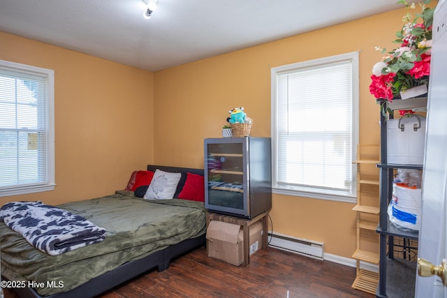 800 S Vance St, Fremont, NC 27830 - bedroom with a baseboard heating unit, multiple windows, and wood finished floors