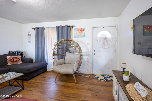 800 S Vance St, Fremont, NC 27830 - living area with dark wood-style flooring and a textured ceiling
