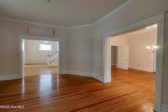 1305 N Market St, Washington, NC 27889 - empty room featuring a chandelier, hardwood / wood-style flooring, ornamental molding, and stairway