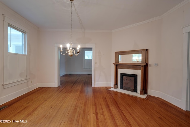 1305 N Market St, Washington, NC 27889 - unfurnished living room with a chandelier, wood-type flooring, a brick fireplace, and ornamental molding