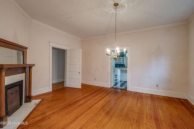 1305 N Market St, Washington, NC 27889 - unfurnished dining area featuring a chandelier, crown molding, a fireplace with flush hearth, and light wood-style floors