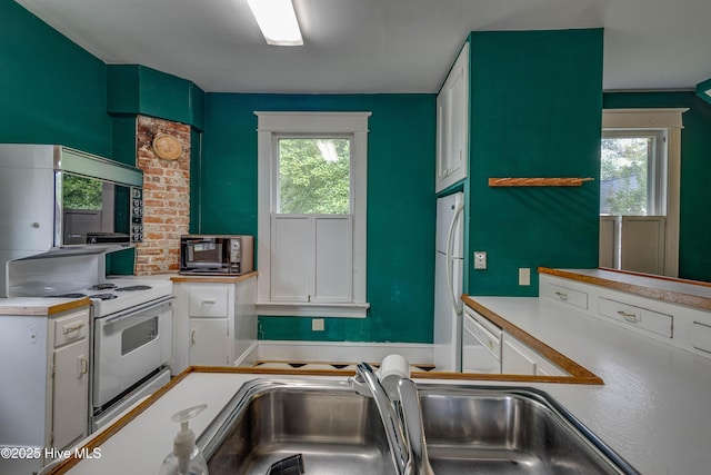 1305 N Market St, Washington, NC 27889 - kitchen featuring white appliances, white cabinetry, and plenty of natural light