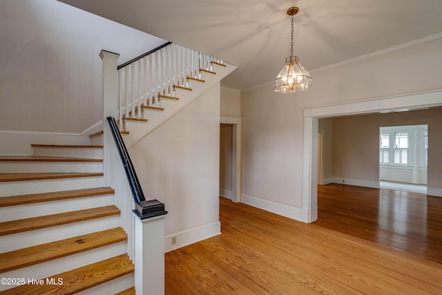 1305 N Market St, Washington, NC 27889 - staircase with crown molding, wood finished floors, and a chandelier