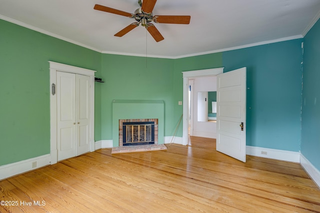 1305 N Market St, Washington, NC 27889 - unfurnished living room featuring a brick fireplace, ceiling fan, light wood finished floors, and ornamental molding