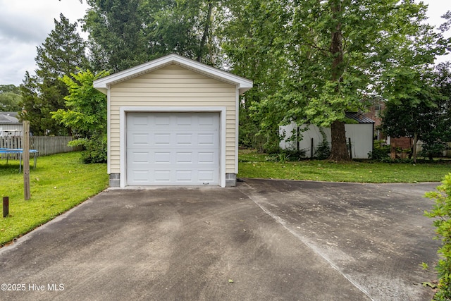 1305 N Market St, Washington, NC 27889 - detached garage featuring asphalt driveway and a trampoline