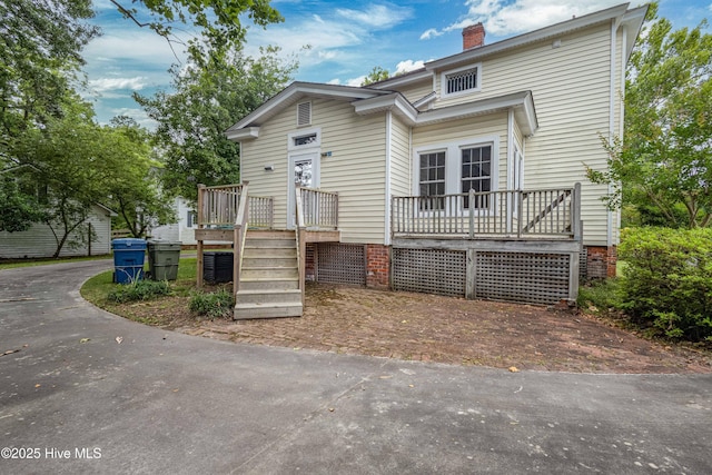 1305 N Market St, Washington, NC 27889 - view of front of home with a chimney and a wooden deck