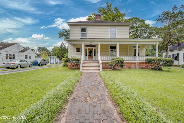 1305 N Market St, Washington, NC 27889 - view of front facade featuring covered porch, a chimney, a front lawn, and a storage unit