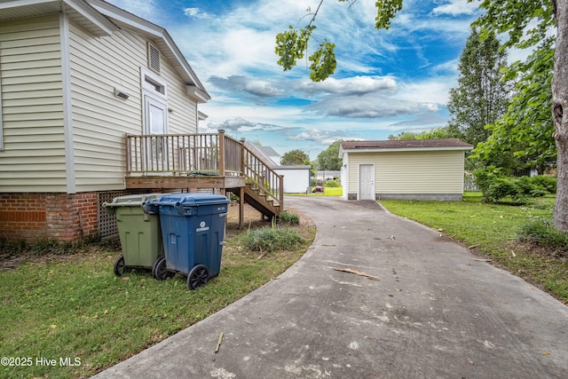1305 N Market St, Washington, NC 27889 - view of property exterior with driveway, a yard, an outbuilding, and stairway