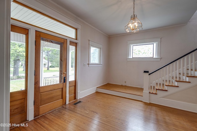 1305 N Market St, Washington, NC 27889 - foyer entrance featuring hardwood / wood-style floors, healthy amount of natural light, stairs, a chandelier, and crown molding