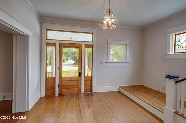 1305 N Market St, Washington, NC 27889 - foyer entrance featuring a chandelier, healthy amount of natural light, light wood finished floors, and ornamental molding