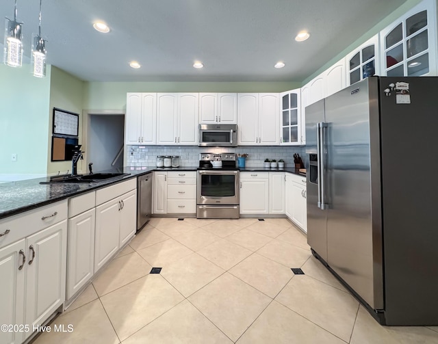 4109 Devonshire Ln, Wilmington, NC 28409 - kitchen featuring appliances with stainless steel finishes, glass insert cabinets, backsplash, pendant lighting, and recessed lighting