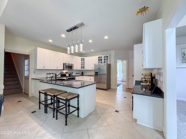 4109 Devonshire Ln, Wilmington, NC 28409 - kitchen featuring stainless steel appliances, backsplash, glass insert cabinets, white cabinetry, and recessed lighting