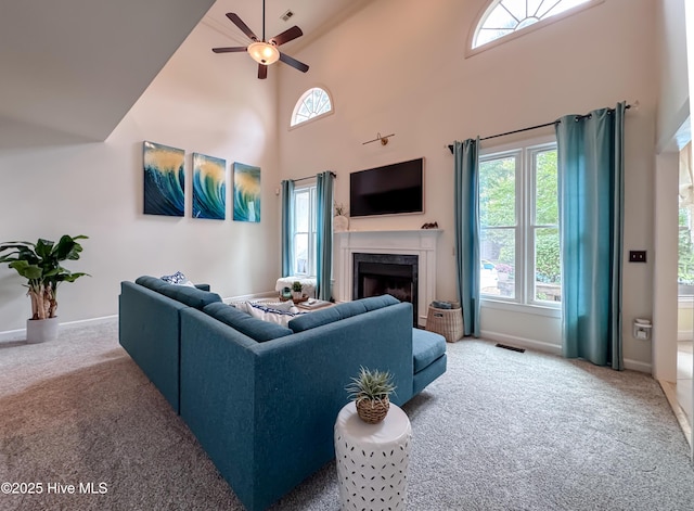 4109 Devonshire Ln, Wilmington, NC 28409 - carpeted living room with a fireplace, a ceiling fan, and a towering ceiling
