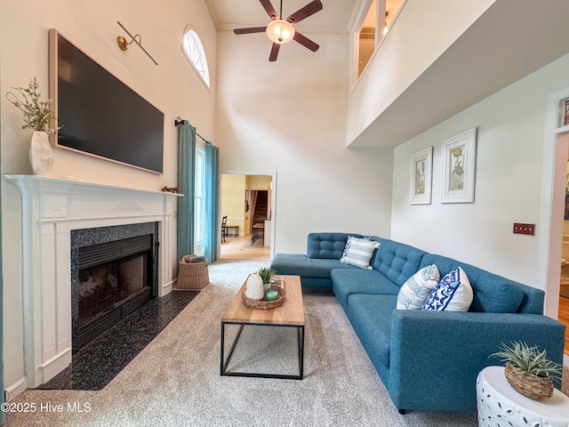 4109 Devonshire Ln, Wilmington, NC 28409 - living room featuring a ceiling fan, a towering ceiling, and a premium fireplace