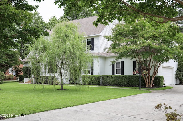4109 Devonshire Ln, Wilmington, NC 28409 - view of property hidden behind natural elements with driveway, a front lawn, roof with shingles, and an attached garage