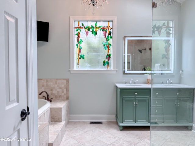 4109 Devonshire Ln, Wilmington, NC 28409 - full bath featuring a chandelier, double vanity, a bath, and tile patterned flooring
