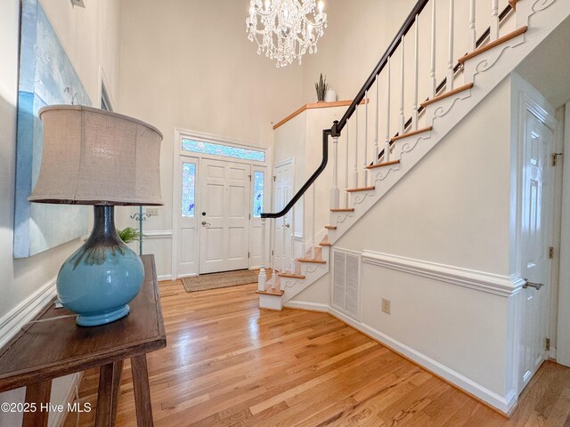 4109 Devonshire Ln, Wilmington, NC 28409 - entrance foyer featuring light wood-style flooring, stairway, a towering ceiling, and a chandelier