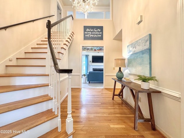 4109 Devonshire Ln, Wilmington, NC 28409 - entrance foyer with wood finished floors, a chandelier, stairway, and a towering ceiling