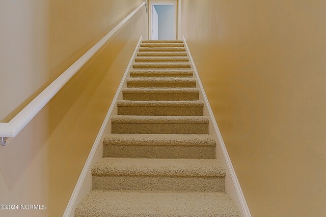 8975 Smithfield Dr NW Apt 2, Calabash, NC 28467 - staircase featuring baseboards
