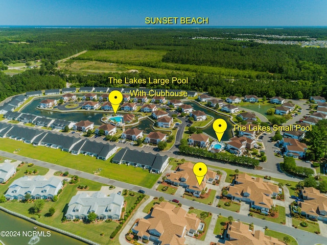 8975 Smithfield Dr NW Apt 2, Calabash, NC 28467 - aerial overview of property's location featuring a heavily wooded area and nearby suburban area