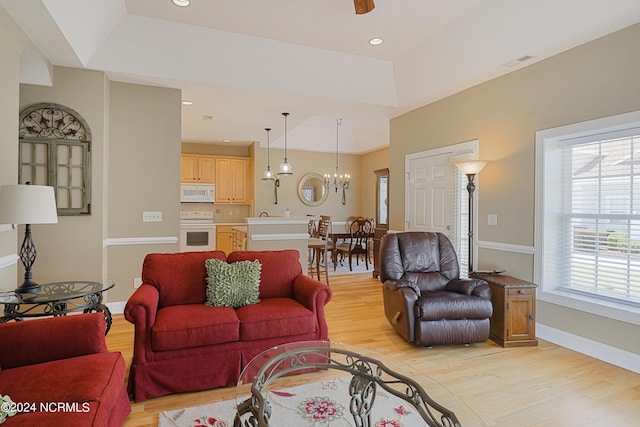 8975 Smithfield Dr NW Apt 2, Calabash, NC 28467 - living area featuring light wood-style floors, a chandelier, a tray ceiling, a ceiling fan, and recessed lighting