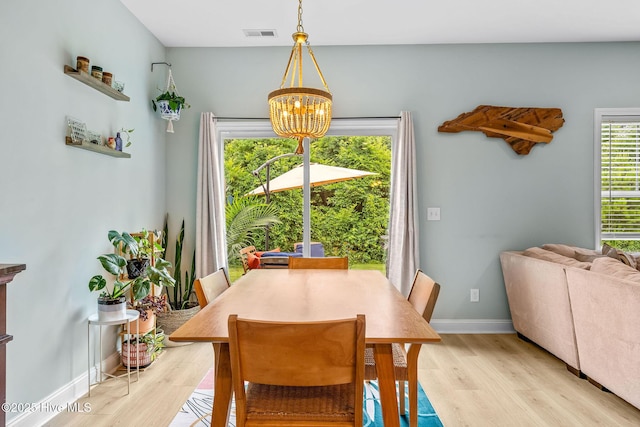 1571 Grey Cliff Run, Wilmington, NC 28405 - dining room with a chandelier and light wood-style flooring
