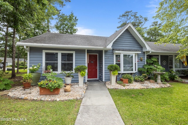 600 N 35th St Unit 201, Morehead City, NC 28557 - view of front facade featuring a front lawn and a shingled roof