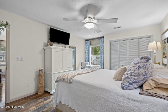 600 N 35th St Unit 201, Morehead City, NC 28557 - bedroom featuring dark wood-type flooring, a closet, ceiling fan, and a textured ceiling