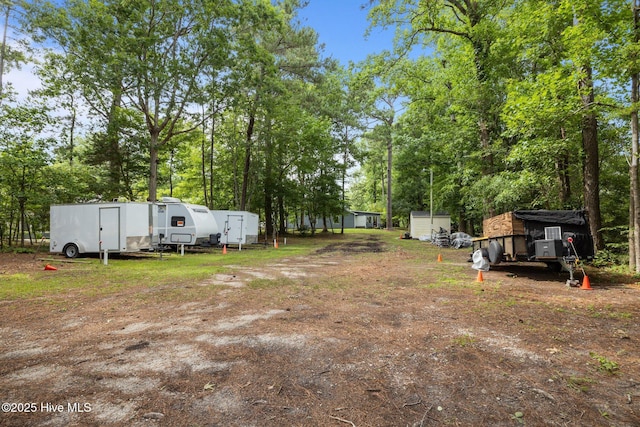 600 N 35th St Unit 201, Morehead City, NC 28557 - view of yard with a storage unit and view of scattered trees