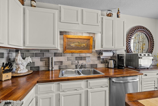 600 N 35th St Unit 201, Morehead City, NC 28557 - kitchen featuring wood counters, stainless steel dishwasher, white cabinetry, tasteful backsplash, and a textured ceiling